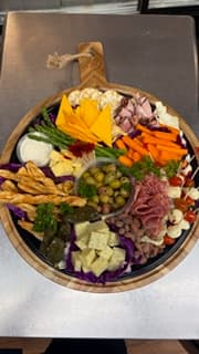 Charcuterie board with cured meats, cheeses, and crackers