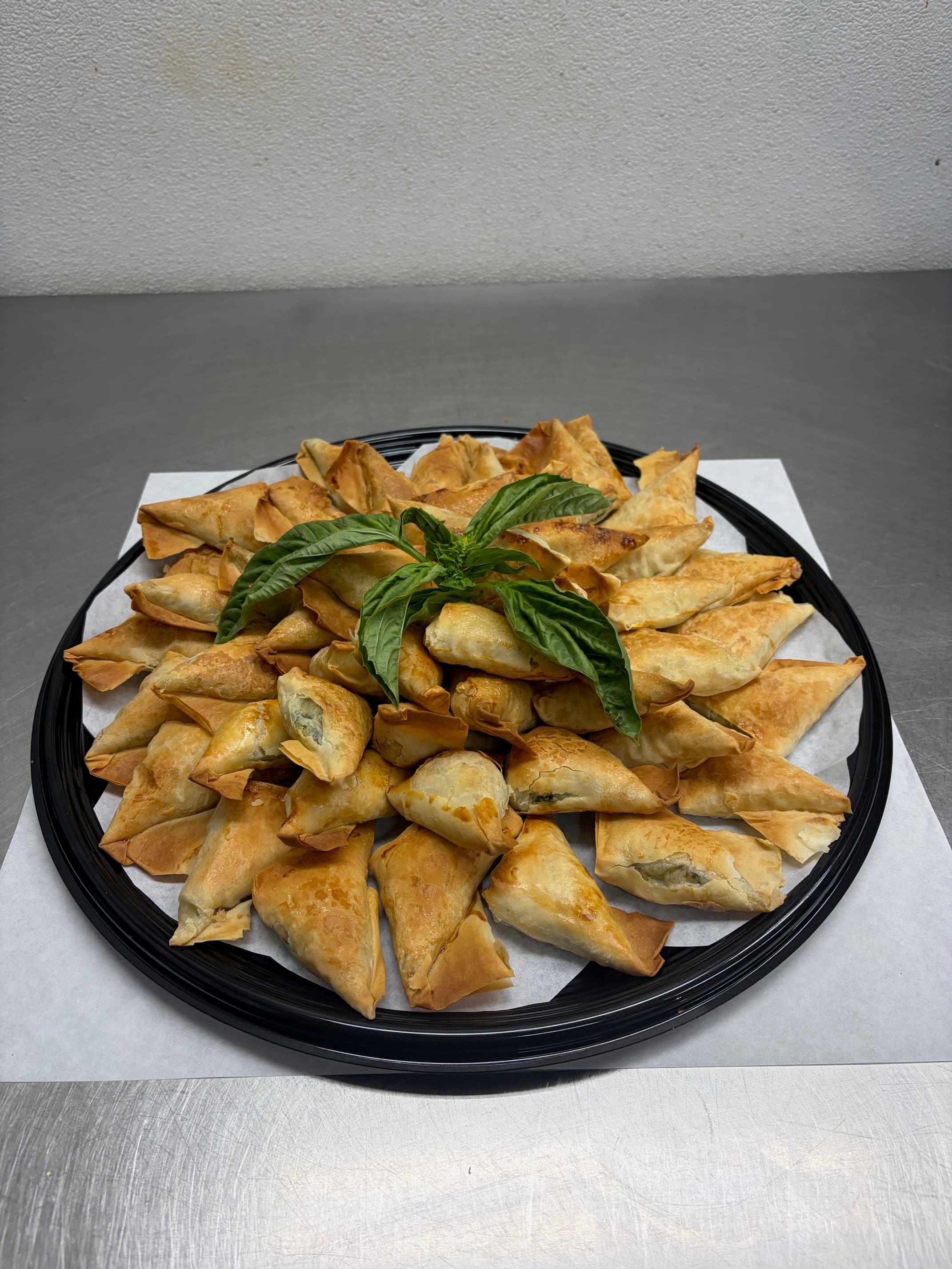 Golden spanakopita and phyllo pastry tray